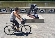 A man rides his bike along the Buenos Aires 