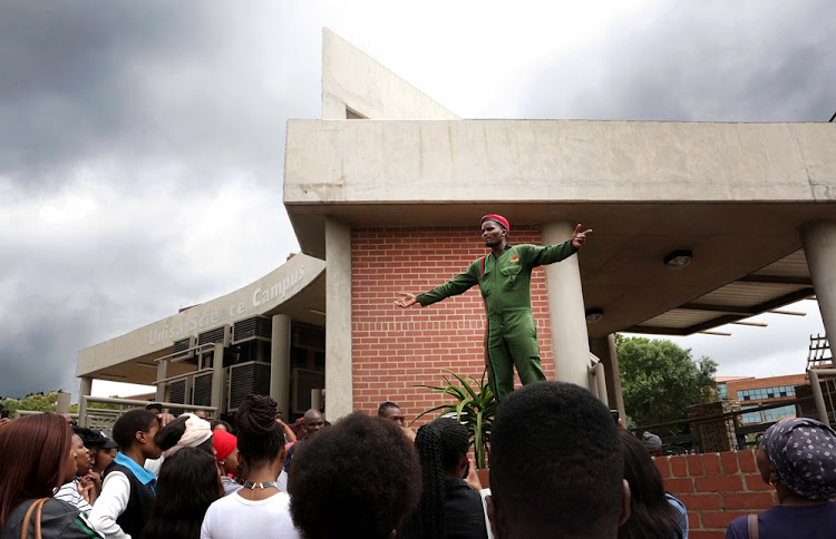 Student representative council undergrad officer Victor Phenyo addresses students outside Unisa's Florida campus in Johannesburg on Monday.