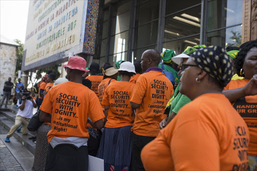 Demonstrators outside the Constitutional Court during hearings on the future of the social grants payment system.