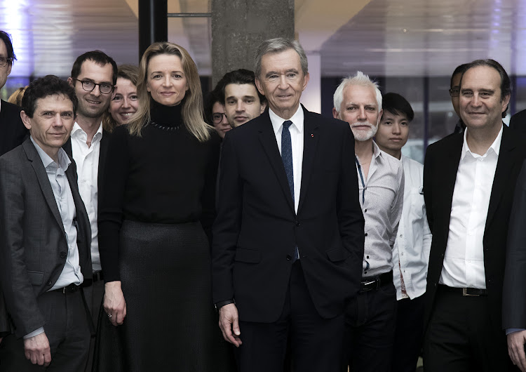 Delphine Arnault, Deputy Chief Executive Officer of Louis Vuitton, Bernard Arnault (C), CEO of the LVMH group.