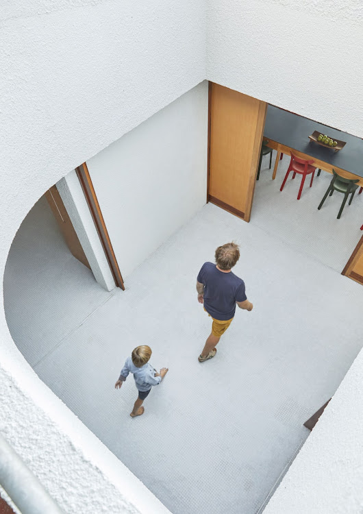Architect Guillaume Pienaar and his son, Gabriel. At the centre of the house is a courtyard that allows light and air into its internal spaces and lets occupants keep all the interior doors open, day and night. This protected outdoor space is also much used on windy days during the summer months.