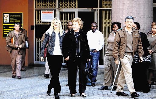 Cezanne Visser leaves the Department of Correctional Services in Pretoria , after serving half of her seven-year sentence for child abuse. With her is her mother, Susan Lemmer. She will be under 'house detention'