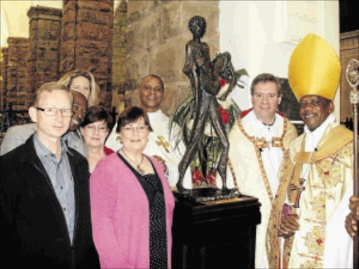 CAST IN BRONZE: Last Sunday, the Cathedral Church of St Mary the Virgin in Johannesburg unveiled 'Sinethemba', a bronze sculpture representing the hope that comes from the past sacrifices of young South Africans. Front row are St Martins' Church representatives Peter Rhonda and Crandle, on the left, the vicar, Reverend Sam Wells, and Anglican Bishop Steve Moreo, right Photo: Victor Mecoamere