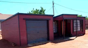 One of the shacks created by Tebogo, which also features a garage. 