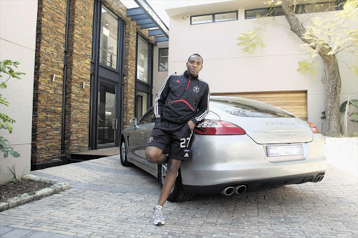Benni McCarthy poses next to his Porsche Panamera. His salary jumped from R1,200 a month when he was playing for Seven Stars to about $80,000 at the age of 17.
