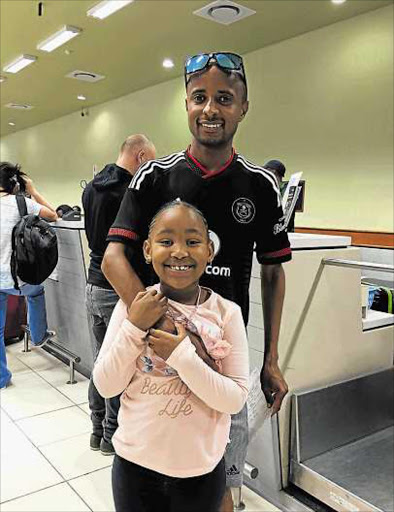 BRING BACK THE TITLE, DADDY: Lusapho April says goodbye to his daughter Avuswa at the East London airport before leaving for Germany earlier this weekPicture: SUPPLIED