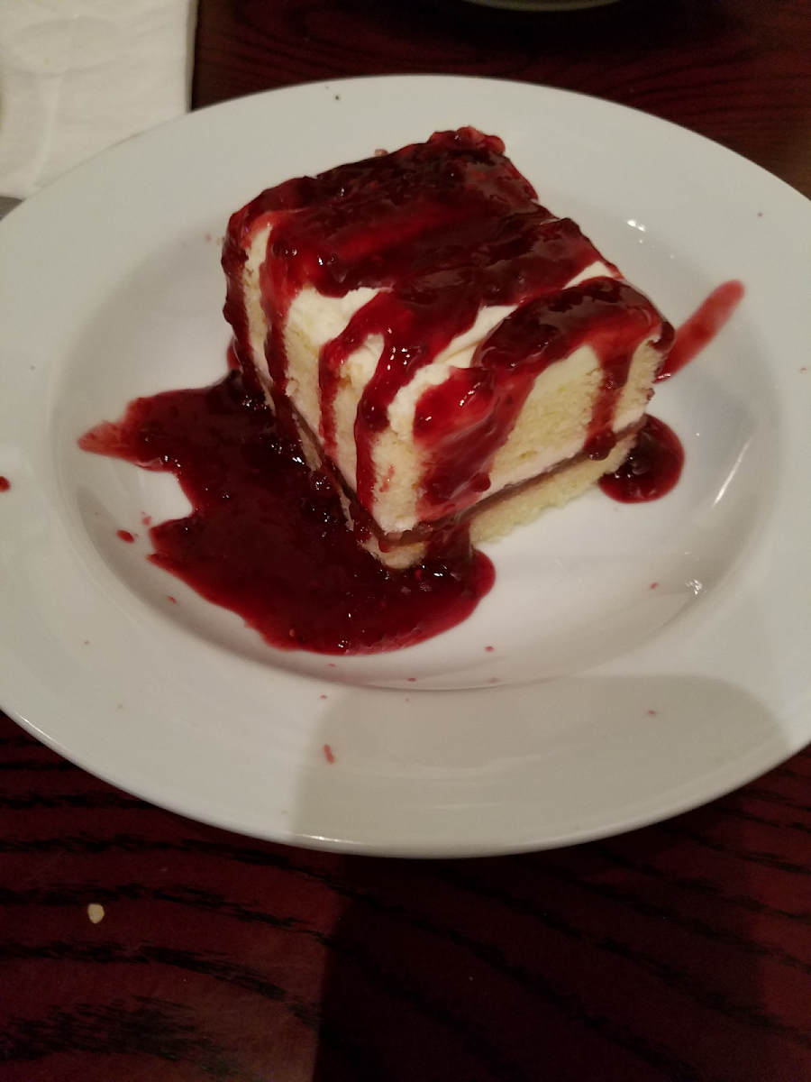 Gluten free white chocolate cake with raspberry sauce.