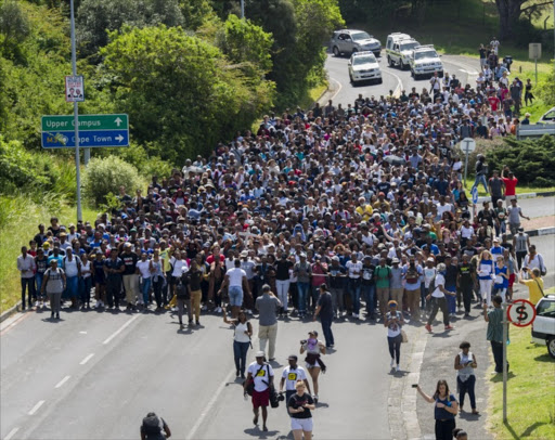 University of Cape Town (UCT) students march from the Upper campus to Bremmer building during the #FeesMustFall protests on October 05 2016 in Cape Town, South Africa. Nearly 1,000 students demanded that the institution's Chancellor Max Price address them. They were however addressed by Professor Anwar Suleman Mall. (Photo by Gallo Images / Beeld / Jaco Marais)