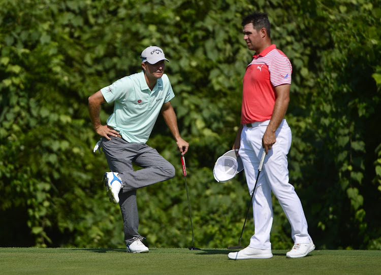 Kevin Kisner (left) and Gary Woodland (right) on the 17th green during the second round of the100th PGA Championship golf tournament at Bellerive Country Club on August 10, 2018 in Saint Louis.