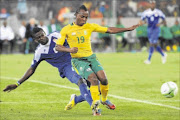 RIDING THE CHALLENGE: Salif Kèita of Central African Republic tackles   May Mahlangu of South Africa during their Fifa 2014 World Cup qualifier
      
       at Cape Town Stadium on March 23
      
      
      
      Photo: Gallo Images