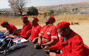 Leader of the EFF (Economic Freedom Fighters) party Julius Malema (3-L) and and Floyd Shivambu (2-R) prior to addressing the media to update the public on coalition talks after the recent local elections.