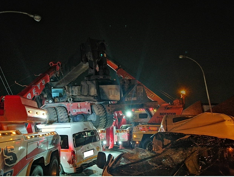 A crane fell off a truck onto two taxis and a car in Durban, killing one person and injuring at least 30 others.