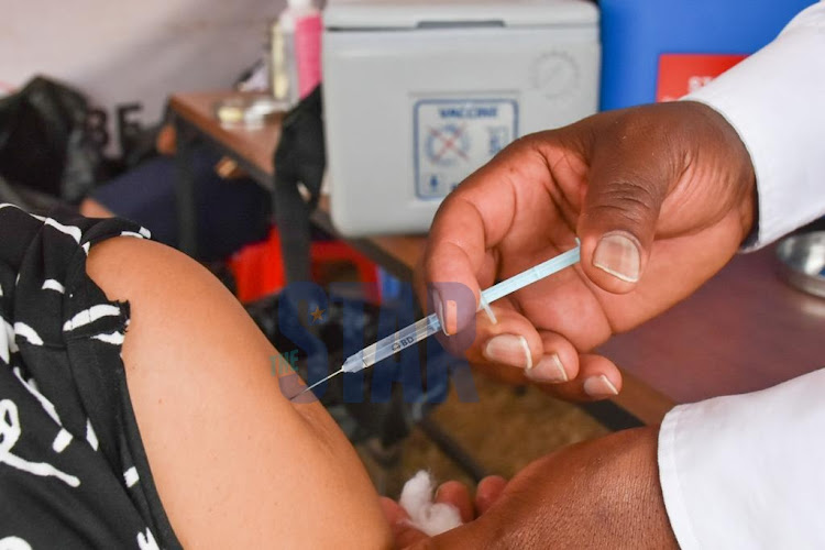 A patient receives the AstraZeneca vaccine at Kenyatta National Hospital, Nairobi during a mass vaccination.