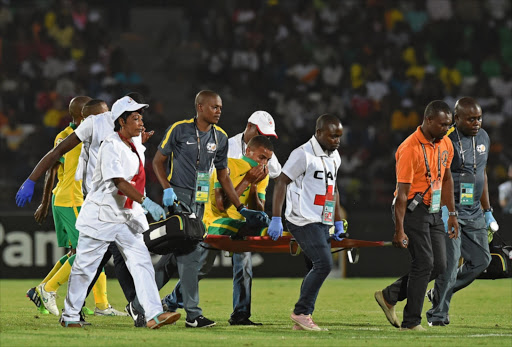 South Africa's defender Rivaldo Coetzee leaves the pitch on a stretcher after getting injured during the 2015 African Cup of Nations group C football match between Algeria and South Africa in Mongomo on January 19, 2015. (Photo by AFP PHOTO/CARL DE SOUZA/Gallo Images)