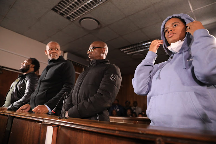 Senohe Matsoara, Zolile Sekeleni, Teboho Lipholo and Dr Nandi Magudumana appear before the Bloemfontein magistrate's court. The doctor's father gazes at her as she shows her face on the instruction of the magistrate.