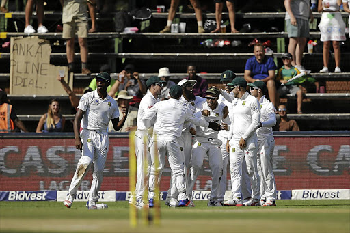 JP Duminy is congratulated by his teammates after he caught batsman Upul Tharanga (not pictured) during the third day of the third test against Sri Lanka at the Wanderers in Johannesburg yesterday.