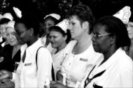 WE PROMISE: International Nurses Day celebrations were held all over South Africa on Monday. These nurses at Garden City Clinic in Johannesburg held a prayer service and lit candles to remind themselves of their vows. Pic. Lucky Nxumalo. 12/05/2008. © Sowetan.