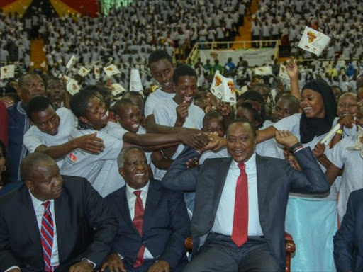 President Uhuru Kenyatta (right) with beneficiaries of the Equity Wings To Fly programme, at Safaricom Stadium Kasarani in Nairobi, where he presided over the launch of the second phase of the initiative, February 5, 2016. Photo/PSCU