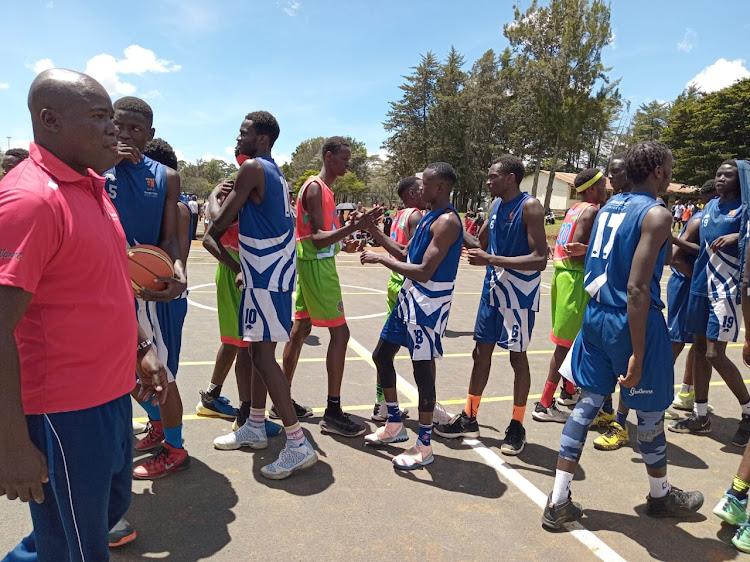 Jomo Kenyatta University of Agriculture and Technology players (in green) shake hands with Strathmore University players during their basketball match at the ongoing Kenya University Sports Federation at the University of Eldoret court