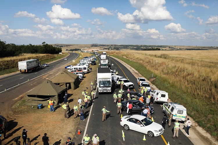 Police pull over cars at a roadblock on the N4 highway towards Pretoria on Friday.