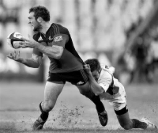 HOLD IT! The Crusaders's Adam Whitelock is tackled by Cheetahs's Naas Olivier during their Super 14 match in Bloemfontein at the weekend. 25/04/09. © Gallo Images