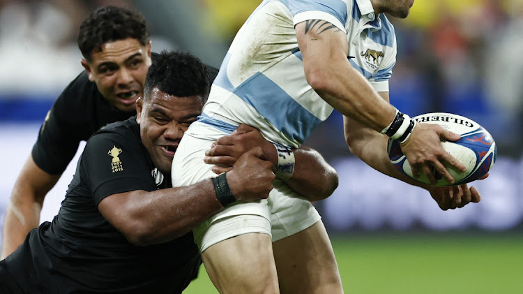 New Zealand's Samisoni Taukei'aho tackles Argentina's Nicolas Sanchez in the Rugby World Cup semifinal at Stade de France, Saint-Denis on October 20, 2023