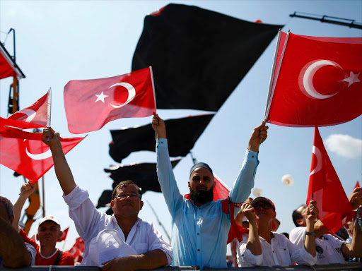 People wave Turkey's national flags ahead of the Democracy and Martyrs Rally, organized by Turkish President Tayyip Erdogan and supported by ruling AK Party (AKP), oppositions Republican People's Party (CHP) and Nationalist Movement Party (MHP), to protest against last month's failed military coup attempt, in Istanbul, Turkey, August 7, 2016 /REUTERS