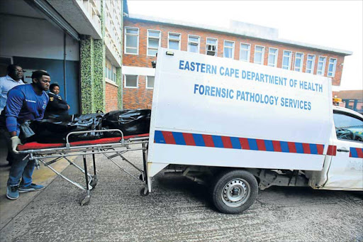 SAD END: The body of the man found hanging in a holding cell of the East London Magistrate Court was removed by state mortuary officials yesterday Picture: SINO MAJANGAZA
