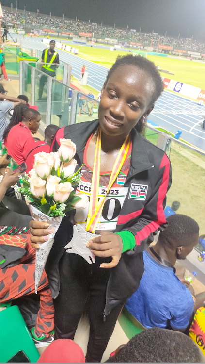 Winnie Bii displays her medal after winning silver in triple jump