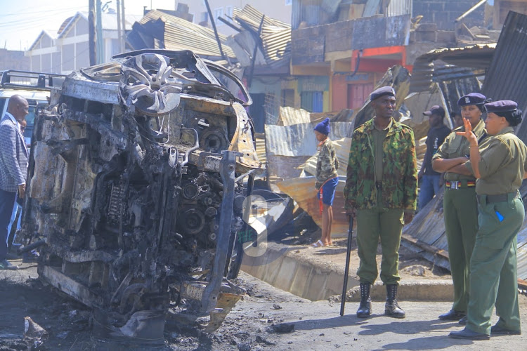 Police officers secure the scene as detectives launch investigations into the gas explosion in Embakasi, Nairobi county, on February 2, 2024.