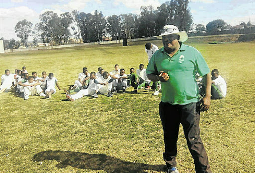 ON THE PROWL: Lawrence Mahatlane, who is the South African under-19 cricket team coach, spent the past week in Mthatha scouting for potential cricket players. He is seen here with youngsters at the Khaya Majola Cricket Oval in Mthatha