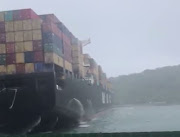 A screenshot of a container-laden ship that was blown into the Durban harbour mouth, blocking it.