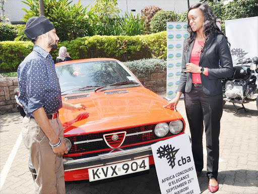 Gursharan Singh (left) shows Christine Apondi (right), the events manager of the Commercial Bank of Africa, his 1980 Alfasud Sprint which he has entered in this year’s CBA Africa Concours d’Elegance. The event will be at the Nairobi Racecourse this Sunday September 25th. /COURTESY