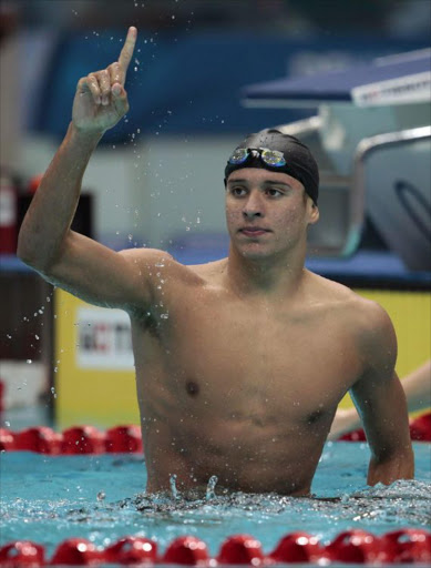 Chad Guy Dertrand Le Clos of South Africa celebrates after wining the men's 200m butterfly finals during the Commonwealth Games in New Delhi October 4, 2010