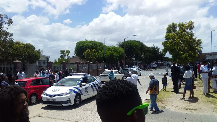Manenberg residents await the arrival of a hearse carrying Rashied Staggie's coffin at The Greens on December 21 2019.
