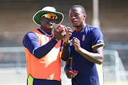 South Africa head coach Ottis Gibson (L) in a discussion with fast bowler Kagiso Rabada (R) during the Sunfoil Test Series training session at Newlands Cricket Ground, Cape Town on 2 January 2018.