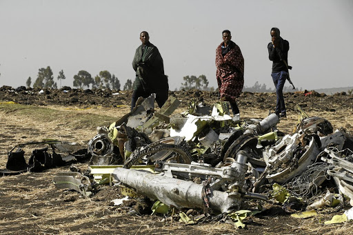 Ethiopian police officers among the debris of the Ethiopian Airlines Boeing 737 Max 8 aircraft that crashed soon after take-off.