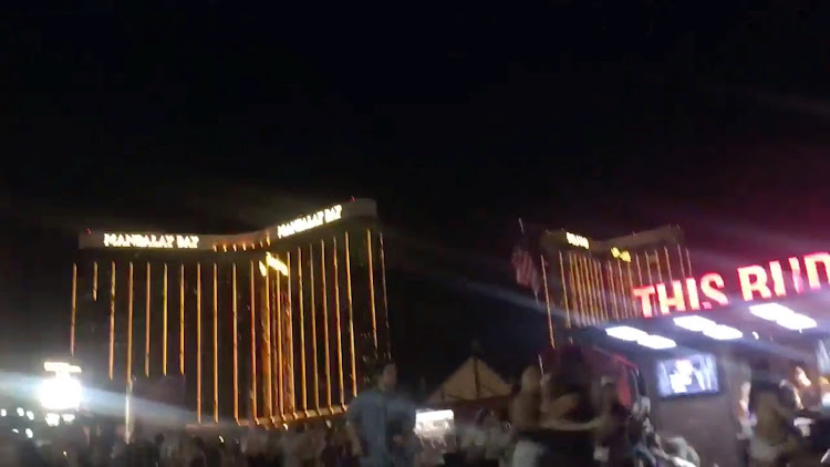 People run outside the Mandalay Bay Hotel after a gunman opened fire on attendees of the Route 91 Harvest Music Festival in Las Vegas, U.S., October 1, 2017 in this still image obtained from social media video.