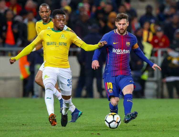 Mojeka Madisha of Mamelodi Sundowns trying to get the ball away from Lionel Messi of Barcelona during the International Club Friendly match between Mamelodi Sundowns and Barcelona FC at FNB Stadium on May 16, 2018 in Johannesburg, South Africa.