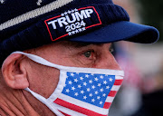 A supporter of U.S. President Donald Trump wearing a face mask takes part in a rally at Beverly Hills Gardens Park in Beverly Hills, California, U.S. January 9, 2021. REUTERS/Ringo Chiu