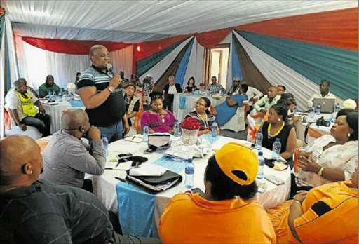 Acting municipal manager for Raymond Mhlaba Municipality, Lusanda Menze (standing)m responds to some of the questions from stakeholders during an event to mark the municipality's first 100 days in office, at the University of Fort Hare in Alice on Friday