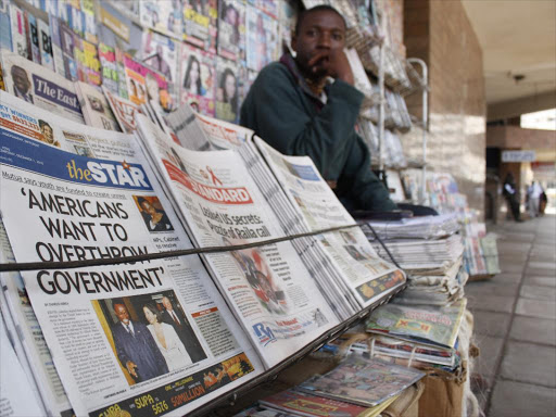 A vendor displays newspapers in a stand in Nairobi.