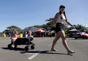 Michelle Francis pulls her sons, Christian and Lihan, at the Red Bull Car Drift in Suncoast, Durban. 