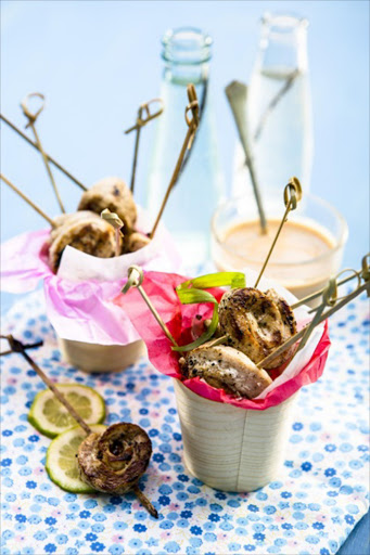 Chicken lollipops with peanut dipping sauce.