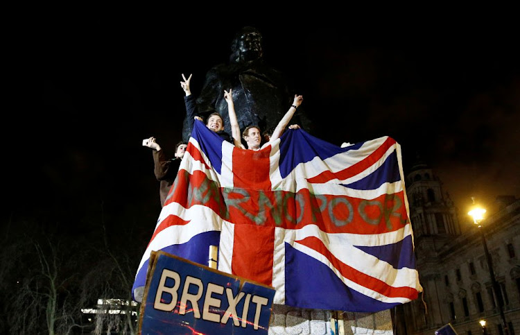 People celebrate at the statue of Winston Churchill as Britain leaves the EU on Brexit day in London, Britain, on January 31 2020.