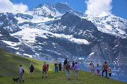 Tourists take in the views from Jungfrau mountain peak in the Swiss Alps.
