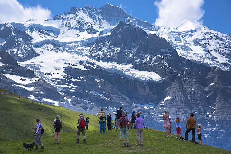 Tourists take in the views from Jungfrau mountain peak in the Swiss Alps.