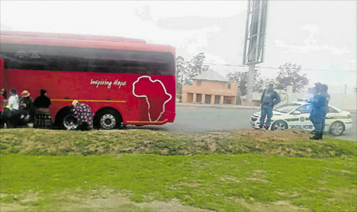 UNDER WATCH; Police keep watch over an AMP bus yesterday. Picture: SUPPLIED