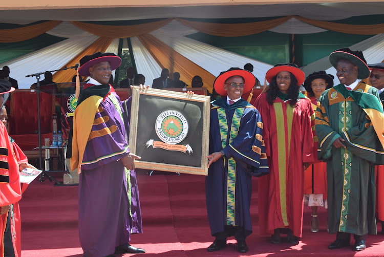 Outgoing Meru University Chancellor Equity CEO James Mwangi gives a Potrait to Safaricom CEO Peter Ndegwa after being inuagurated as the second Chancellor of the university