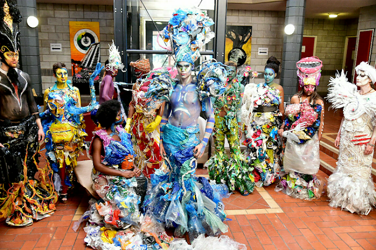Student and performance artist Luke Rudman, front, dressed 10 models in outfits made from rubbish in a Greenpeace collaboration at NMU on Wednesday. Alexia Kalenga sits next to him as fellow models look on